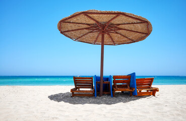 Tropical sandy beach on a sunny day, summer vacation concept.