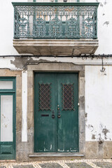 Green door and balcony on a building in Angra do Heroismo.