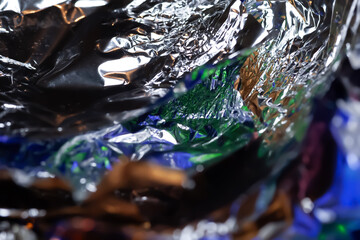 Abstract texture. Crumpled aluminum foil. Sparkling color foil