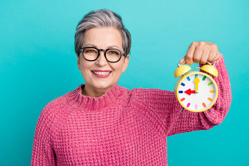 Photo of optimistic nice woman with short hair dressed pink sweater in glasses hold alarm manage...