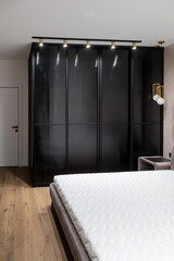 Metal partition of the dressing room in the bedroom, aluminium sliding system. The concept of modern interior and design.