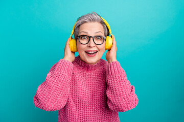Photo of overjoyed woman wear pink sweater in glasses touch headphones inpressed by sound quality...