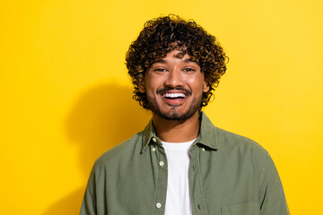 Portrait photo of young funny very optimistic friendly smiling hispanic guy in khaki shirt isolated...
