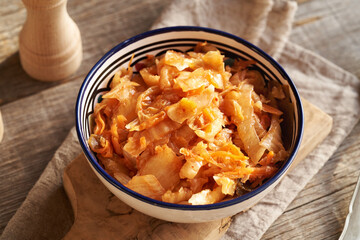 Fermented kim chi in a bowl on a table, top view