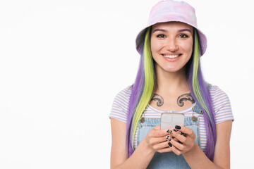 Cropped image of caucasian young teenager woman girl with dyed bright hair and tattoo using smart phone online, surfing social media, e-banking, e-learning isolated in white background