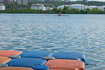 Floating pier made of composite plastic blocks on the river, sea. Plastic bridge on a lake