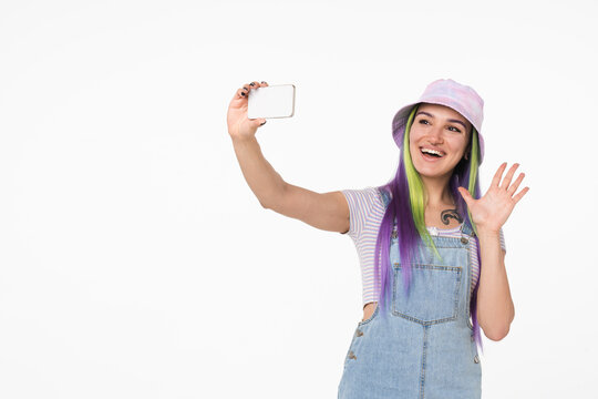 Young teenage girl woman hipster using cellphone for selfie, videocall conversation online, vlogging blogging for social media isolated in white background
