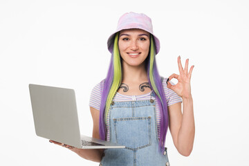 Smiling young caucasian teenage woman girl hipster using laptop for e-learning working on distance...