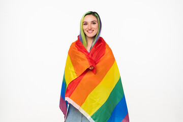 Happy activist caucasian young hipster teenage girl holding rainbow LGBT flag for showing freedom...