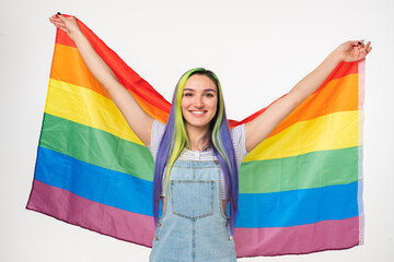 Young hipster teenage girl covering with LGBT flag. Sexual minorities rights. Free love for gays...