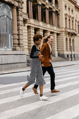 Stylish couple crossing the street in a cozy urban scene