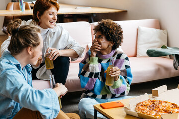 Colleagues relaxing in co-working space with snacks and drinks