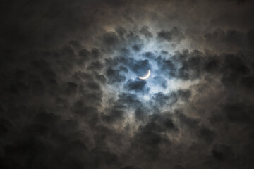 Near total eclipse of the Sun. The moon covers the sun in a solar eclipse and cloudy dramatic sky. Nature phenomenon. 