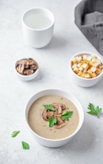 Mushroom cream soup with parsley in a bowl
