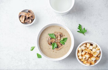 Mushroom cream soup with parsley in a bowl