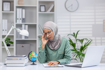 Tired and tired online teacher, woman in hijab working in home office remotely, teaching students...