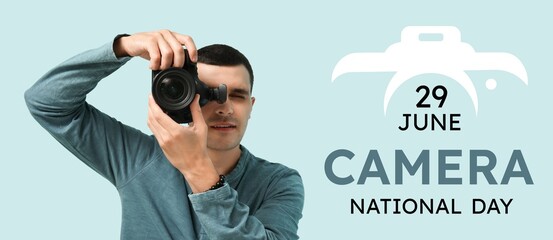 Male photographer on light blue background. Banner for National Camera Day