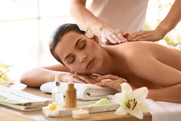 Obraz na płótnie Canvas Young woman getting massage in spa salon, closeup