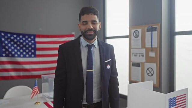 Hispanic man in a suit stands thoughtfully at a us polling place with american flags.