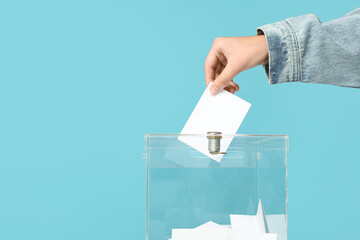 Voting woman near ballot box on blue background