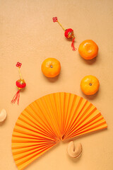 Fortune cookies with mandarins and Chinese symbols on beige background. New Year celebration
