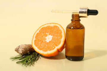 Bottle of essential oil and natural ingredients on color background