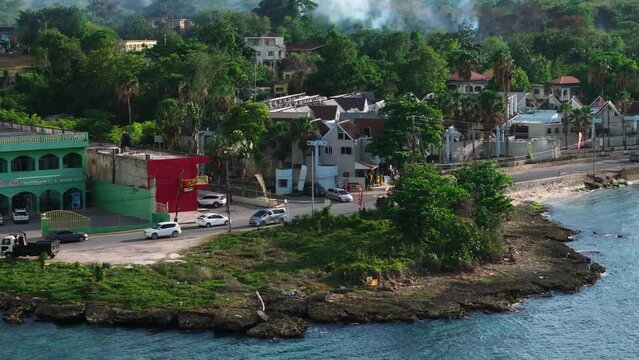 Discover the charm of a Jamaican coastal town from above with breathtaking aerial views. Colorful buildings, lush greenery, and a tranquil oceanfront in this tropical paradise
