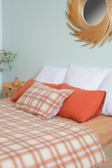 Interior of stylish bedroom with bed, bedside table and pillows