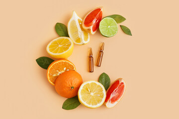 Composition with ampules of vitamin C and fresh citrus fruits on color background
