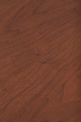 Walnut wood grain pattern. Dark wood surface texture photograph.