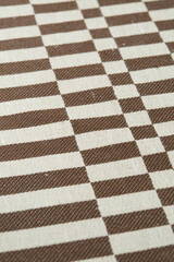 Retro brown and white geometrical pattern. Vintage woven upholstery fabric texture. Close-up detail...
