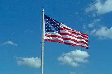 Obraz premium A large American flag billowing in the sky, symbolizing patriotism and freedom.
