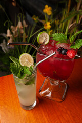 Variety of cocktails in an elegant bar decorated with bottles and sunflowers. 