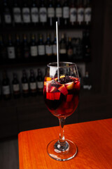Variety of cocktails in an elegant bar decorated with bottles and sunflowers. 