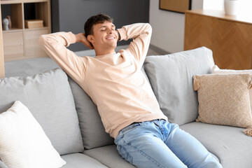 Young man resting on sofa at home