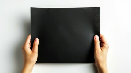 holding balck paper white backgrond