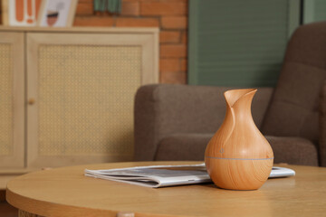 Vase and magazine on wooden table in living room, closeup