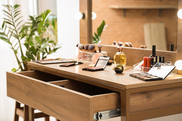 Makeup products on table in dressing room, closeup