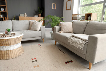 Interior of modern living room with grey sofas and coffee table