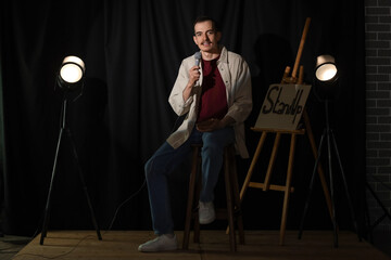 Standup comedian with microphone performing on stage