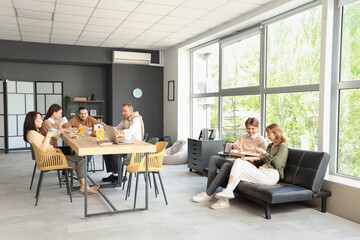 Business colleagues having lunch in office kitchen