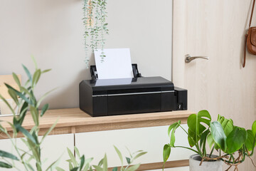 Modern printer on commode in light office