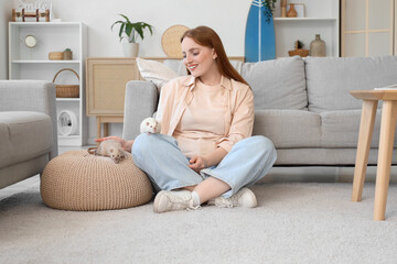 Beautiful redhead woman with cute rats sitting on floor at home