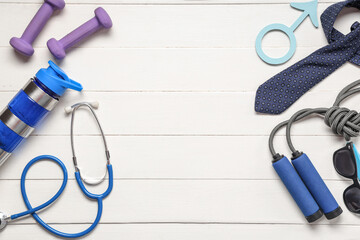Tie, skipping rope, stethoscope and male sign on white wooden background. Prostate cancer awareness