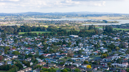 Aerial view of a suburban neighborhood with a construction site in the center, surrounded by...