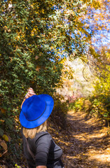 Blue hatted blonde scopes out fall foliage in October