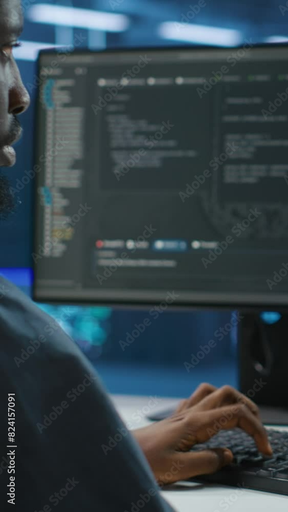 Poster vertical video technician doing system analysis, typing data on pc, doing needed adjustments in supe