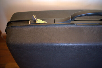 Old big suitcase with keys. 	
