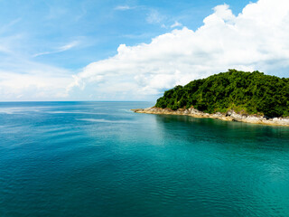 Obraz premium Aerial view of a blue sea surface water texture background,Sun reflections over ocean, Aerial flying drone view Waves water surface texture on sunny tropical ocean in Phuket island Thailand