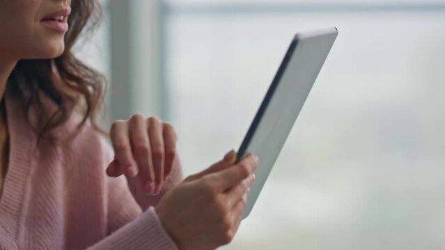 Smiling housewife swiping tablet reading at kitchen closeup. Lady holding pad